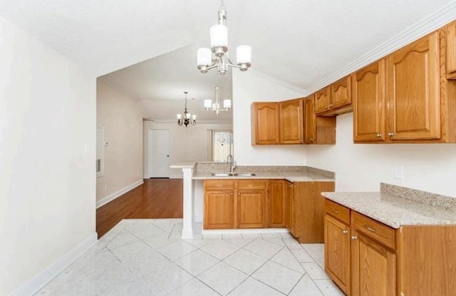 kitchen with lofted ceiling, decorative light fixtures, a chandelier, sink, and light tile floors