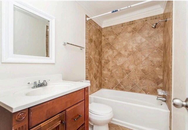 full bathroom with crown molding, large vanity, toilet, and tiled shower / bath combo