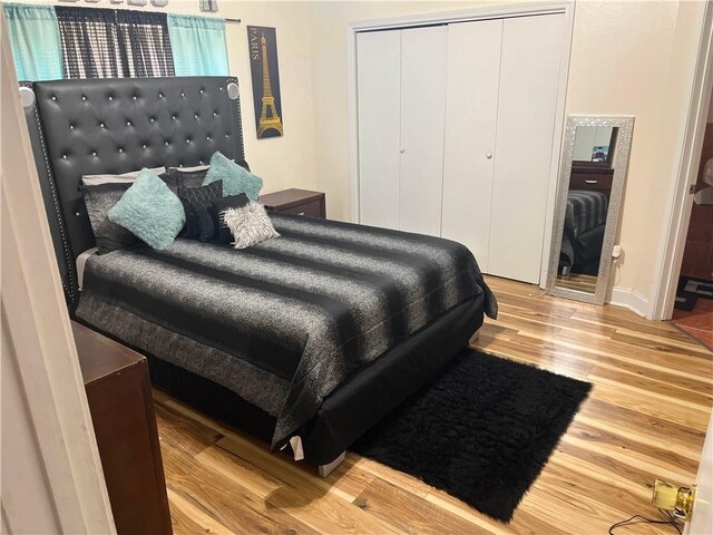 bedroom with a closet and light wood-type flooring