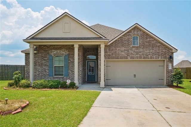 view of front of home with a garage and a front lawn