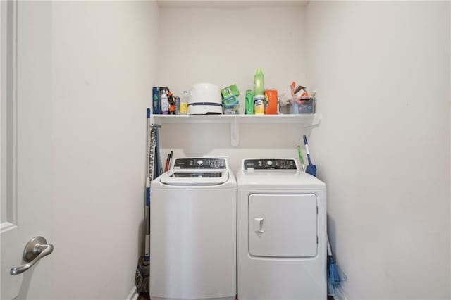 clothes washing area featuring washer and clothes dryer