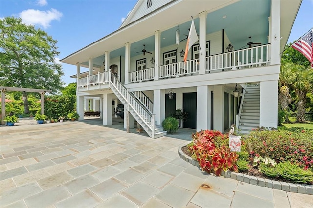 back of house with covered porch, ceiling fan, and a patio area