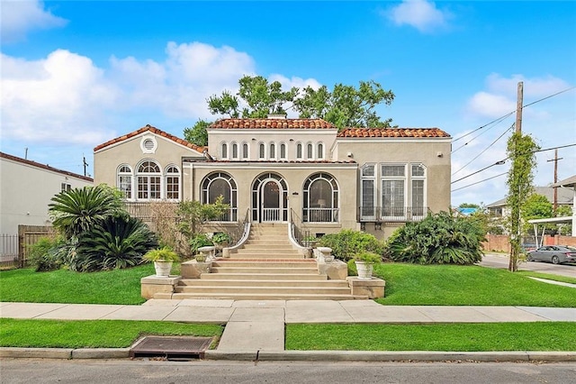 mediterranean / spanish house featuring a front yard