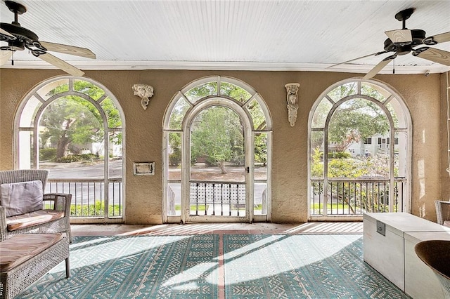 sunroom / solarium with ceiling fan and a pool