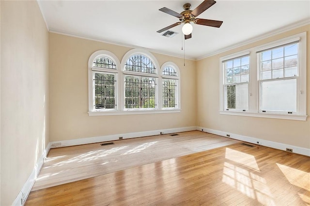 unfurnished room featuring ceiling fan, light hardwood / wood-style floors, and ornamental molding