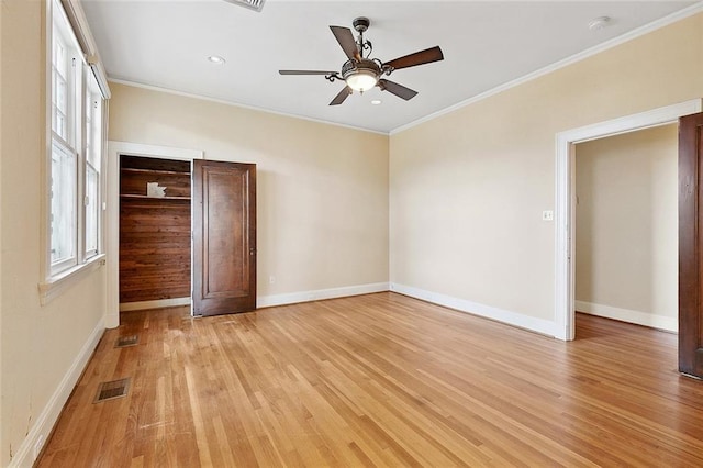 unfurnished bedroom with a closet, light hardwood / wood-style flooring, ceiling fan, and ornamental molding