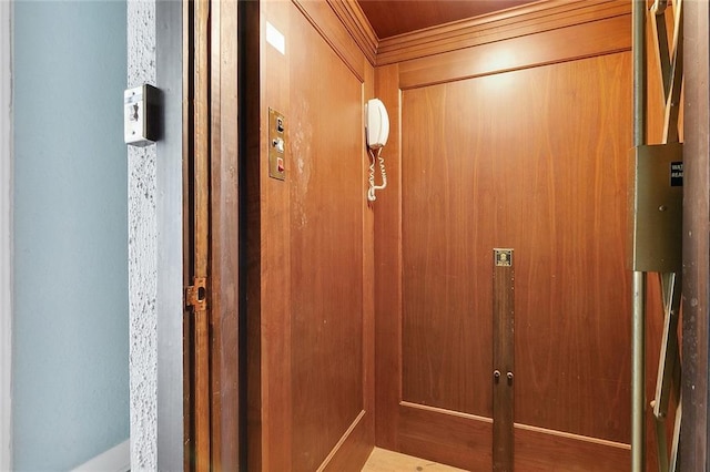 room details featuring elevator and wooden walls