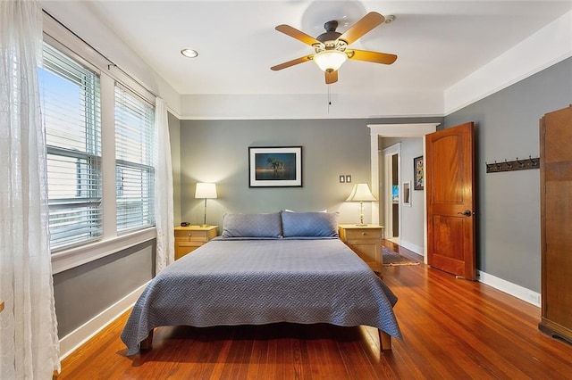 bedroom with ceiling fan and dark wood-type flooring