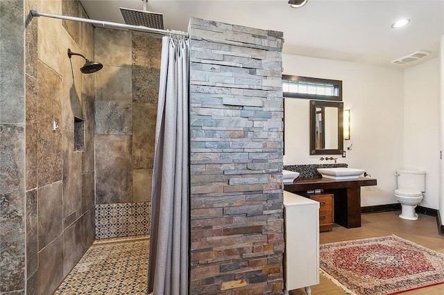 bathroom with toilet, a shower with shower curtain, hardwood / wood-style floors, and sink