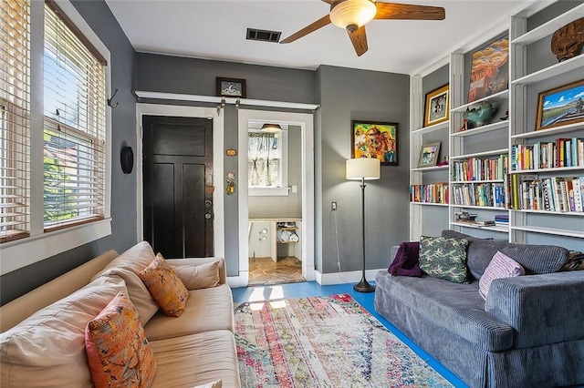 living room with ceiling fan and a healthy amount of sunlight