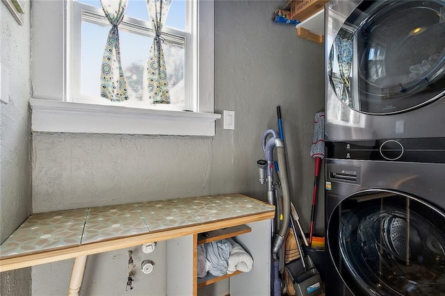 washroom featuring stacked washing maching and dryer