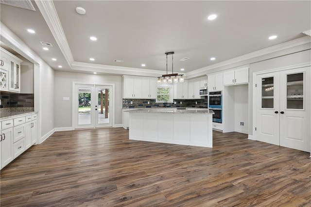 kitchen with decorative light fixtures, french doors, and white cabinets