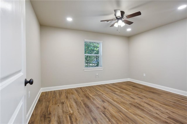 empty room with ceiling fan and wood-type flooring