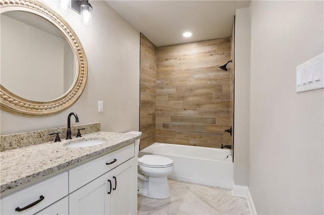 full bathroom with tiled shower / bath, vanity, and toilet