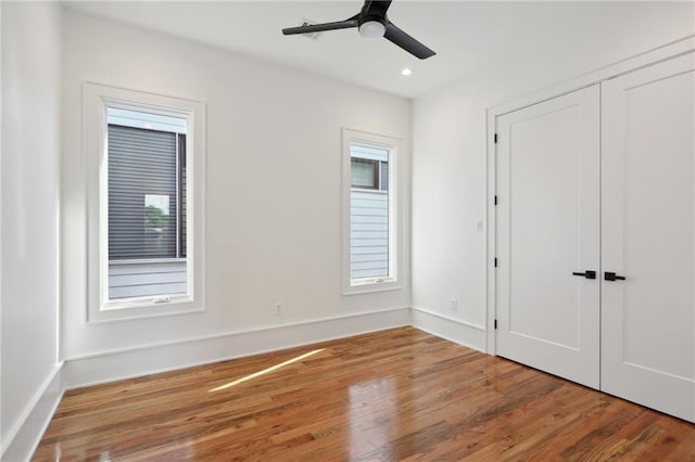 unfurnished bedroom featuring ceiling fan and hardwood / wood-style flooring