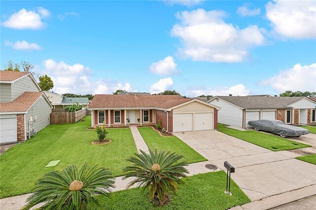 ranch-style house featuring a garage and a front lawn