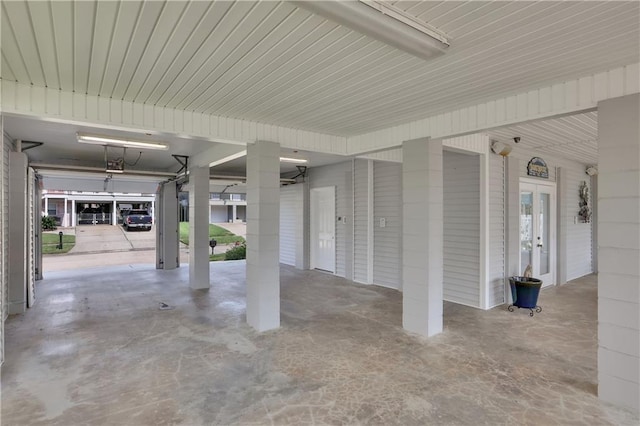 garage with a garage door opener and a carport