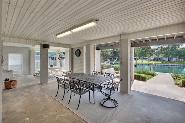 view of patio with a water view