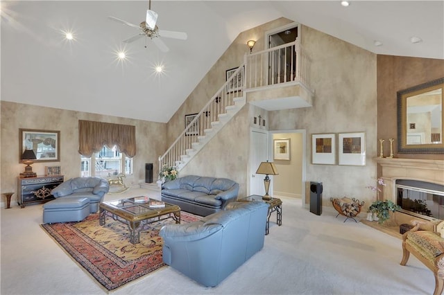 living room featuring light carpet, high vaulted ceiling, and ceiling fan