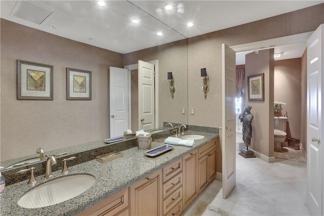 bathroom with vanity and toilet