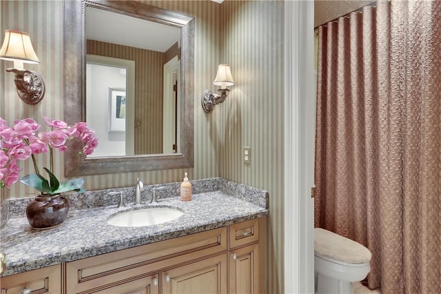 bathroom with vanity and toilet