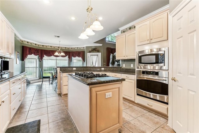 kitchen with a kitchen island, appliances with stainless steel finishes, pendant lighting, light tile patterned floors, and kitchen peninsula