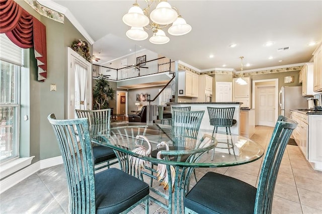 dining room with crown molding, a healthy amount of sunlight, ceiling fan with notable chandelier, and light tile patterned floors