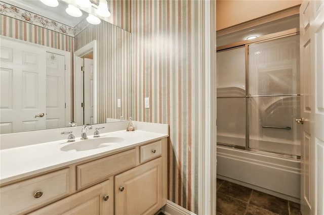 bathroom with vanity and shower / bath combination with glass door