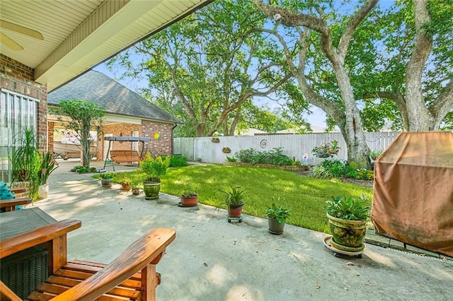 view of patio with area for grilling and ceiling fan