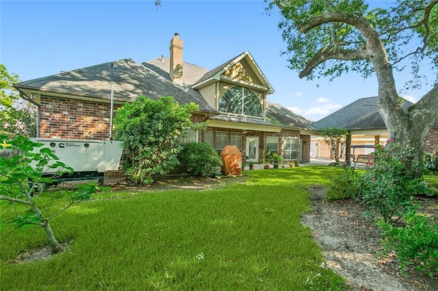 back of house featuring a yard