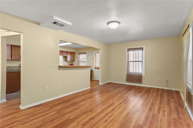 unfurnished living room with light wood-type flooring