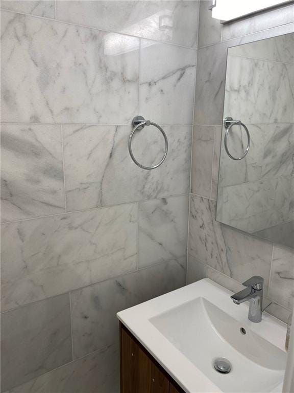 bathroom with tile walls and vanity