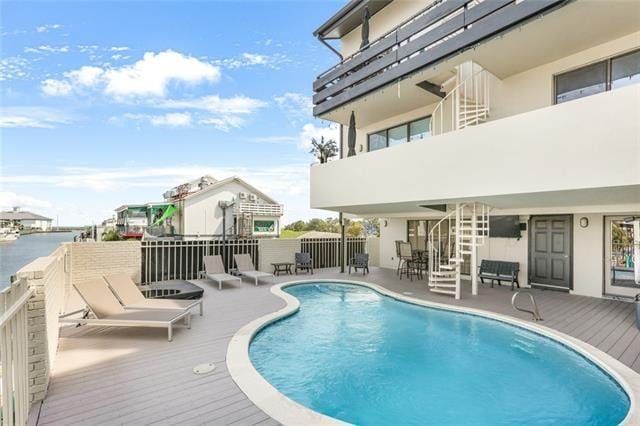 back of house featuring a pool side deck