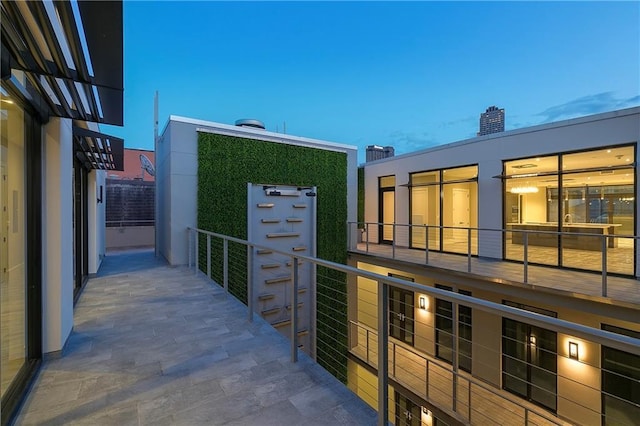 view of balcony at dusk