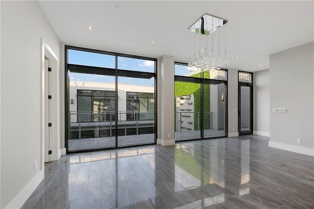 917 Conti St Unit 103, New Orleans, LA 70112 - spare room with plenty of natural light, expansive windows, and wood finished floors
