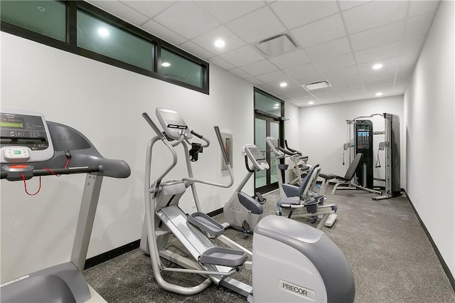 exercise room with a paneled ceiling