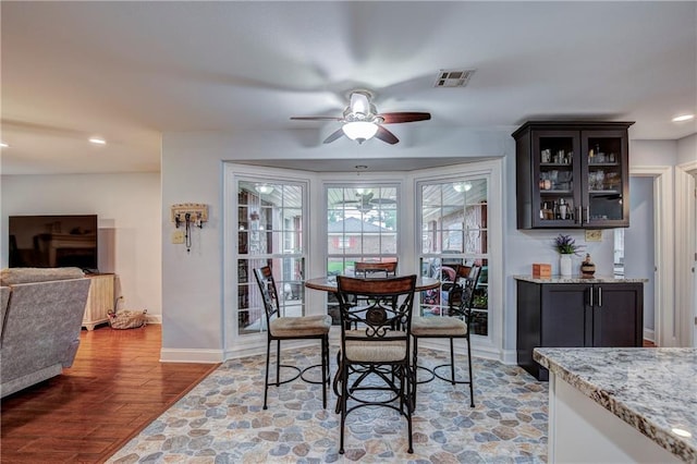 dining space featuring ceiling fan and hardwood / wood-style floors