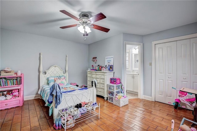 bedroom with ceiling fan, wood-type flooring, and a closet