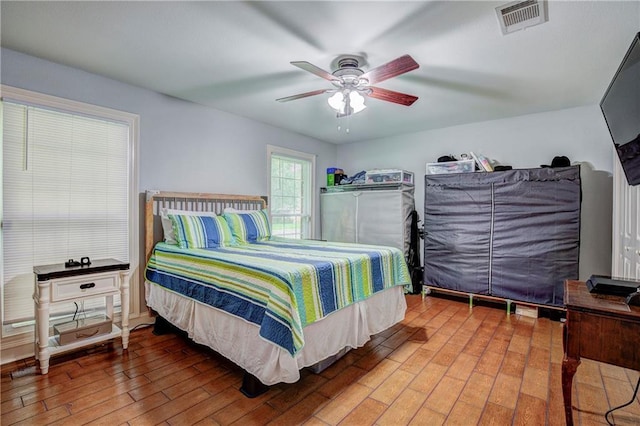 bedroom with wood-type flooring and ceiling fan