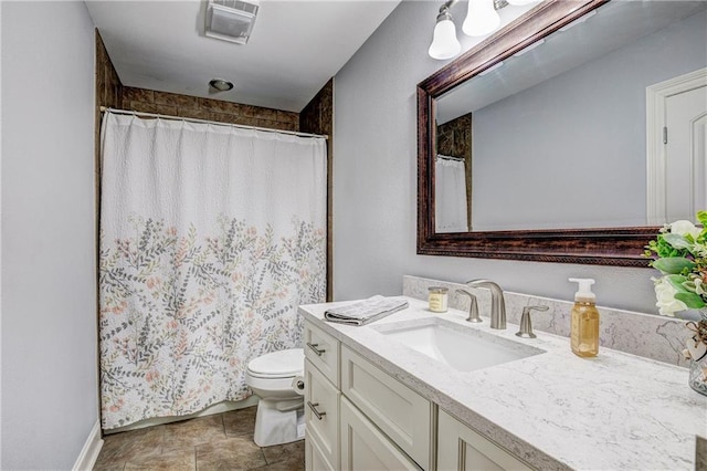 bathroom with vanity, a shower with shower curtain, and toilet