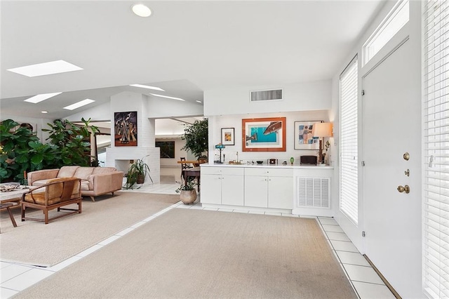 interior space with lofted ceiling and tile patterned flooring