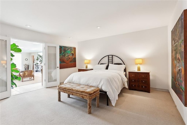 carpeted bedroom with access to outside and french doors