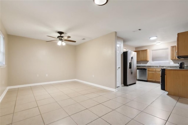 kitchen featuring ceiling fan, light tile patterned flooring, sink, and appliances with stainless steel finishes