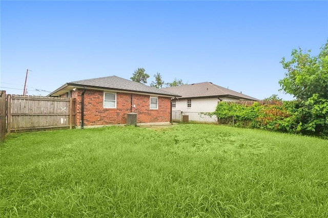 back of property featuring a yard and cooling unit