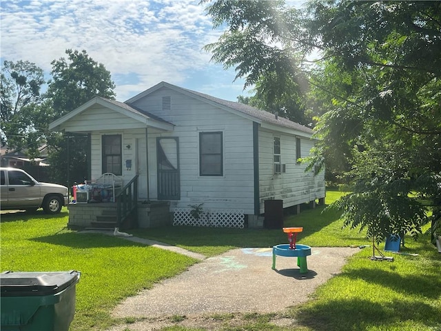 bungalow-style home with a front yard