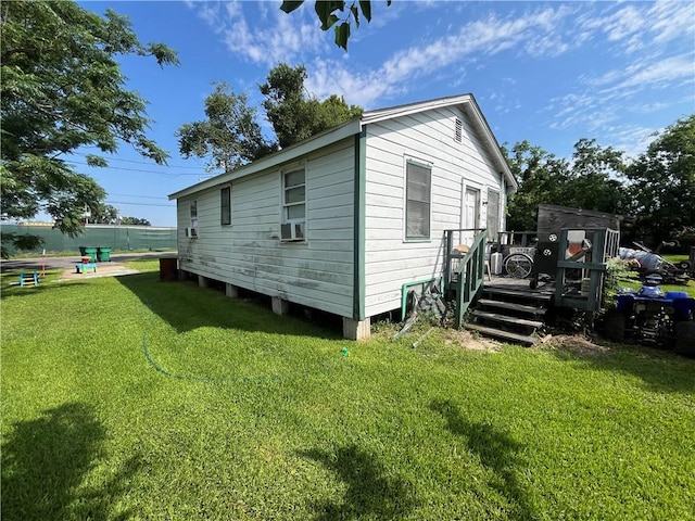 view of side of property with a lawn