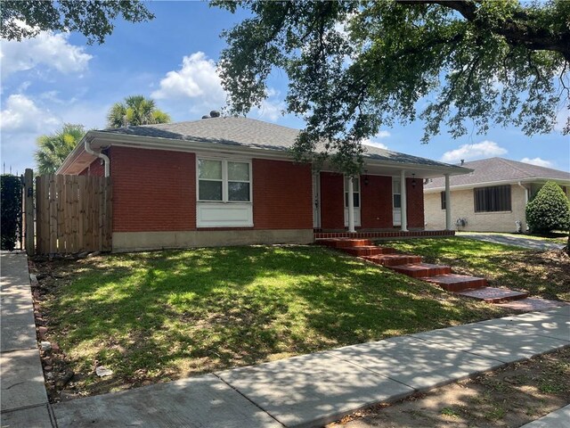 ranch-style house with a front lawn