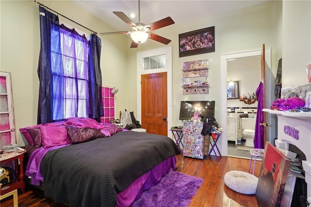 bedroom with ceiling fan, hardwood / wood-style floors, and ensuite bath