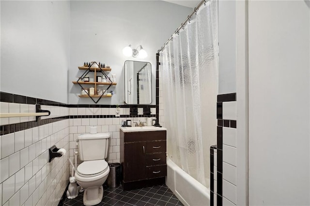 full bathroom with tile patterned floors, tile walls, toilet, vanity, and shower / bathtub combination with curtain