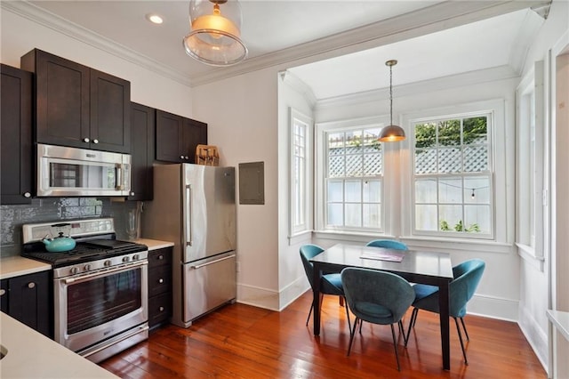 kitchen with dark brown cabinetry, appliances with stainless steel finishes, decorative light fixtures, dark wood-type flooring, and tasteful backsplash